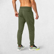 Rear view of Army Green GPW Men's Sweatpants showcasing their flexible and comfortable fit.