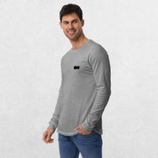 Model wearing the Athletic Heather GPW Long Sleeve Tee paired with jeans in a Studio Background.