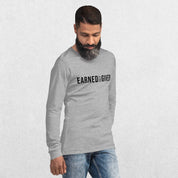 Model Wearing Athletic Heather GPW Earned Not Given Unisex Motivational Long Sleeve Tee in a studio background