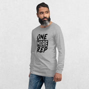 Model wearing the Athletic Heather GPW One More Rep Unisex Motivational Long Sleeve Tee with jeans in studio background.