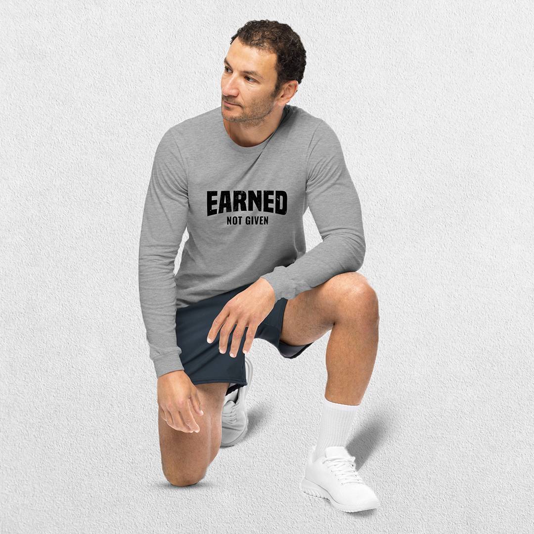 Model Wearing Athletic Heather GPW Unisex Athletic Long Sleeve Tee - Earned Not Given in a studio background