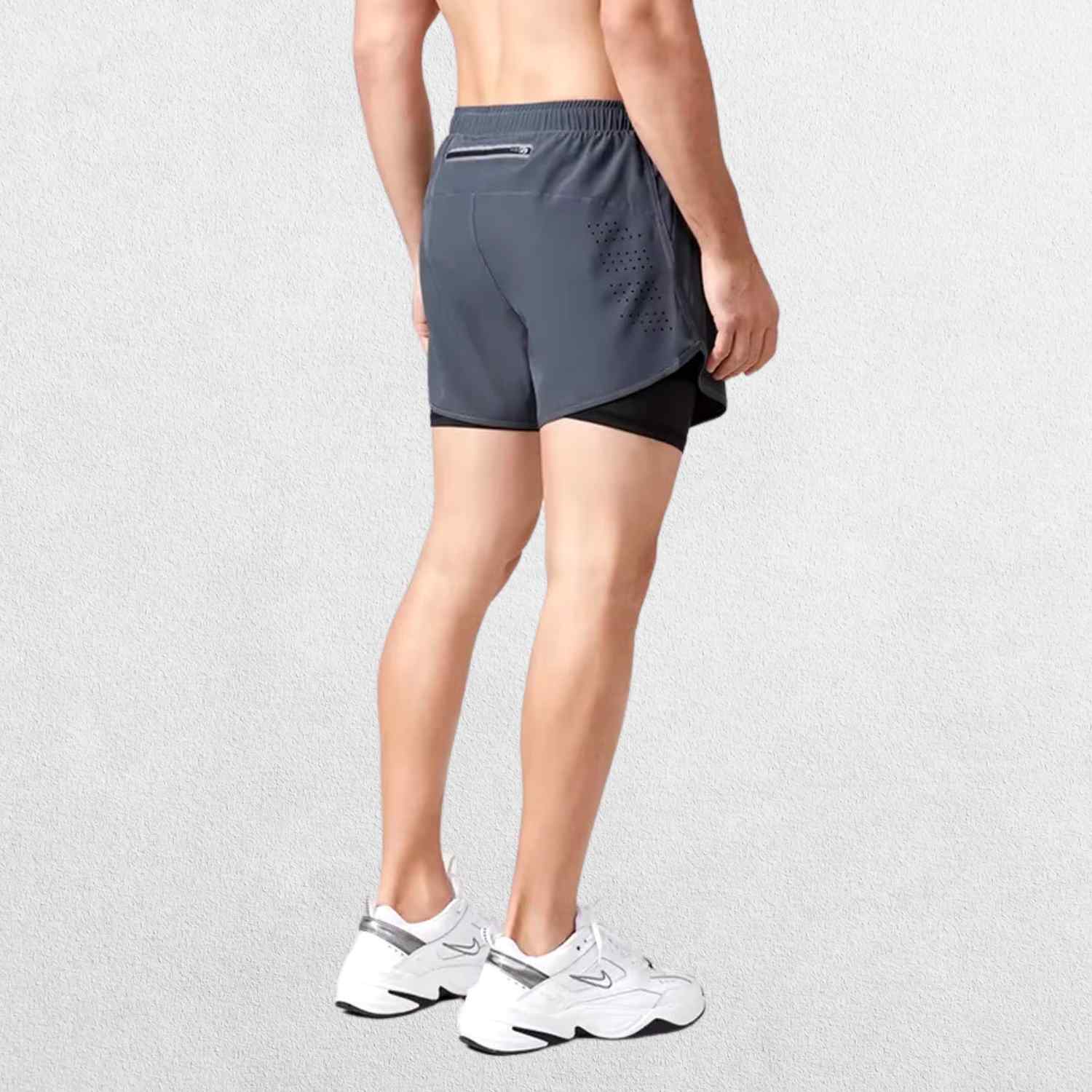 "Back view of the GPW High-Performance Men’s Running Shorts in dark grey, showing the stylish cut, rear pocket, and durable stitching against a professional studio setting."