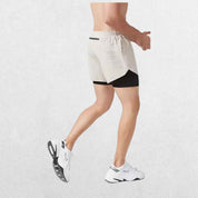 Back view of the GPW High-Performance Men’s Running Shorts in white, featuring a comfortable fit, rear pocket, and moisture-wicking fabric against a plain studio setting.