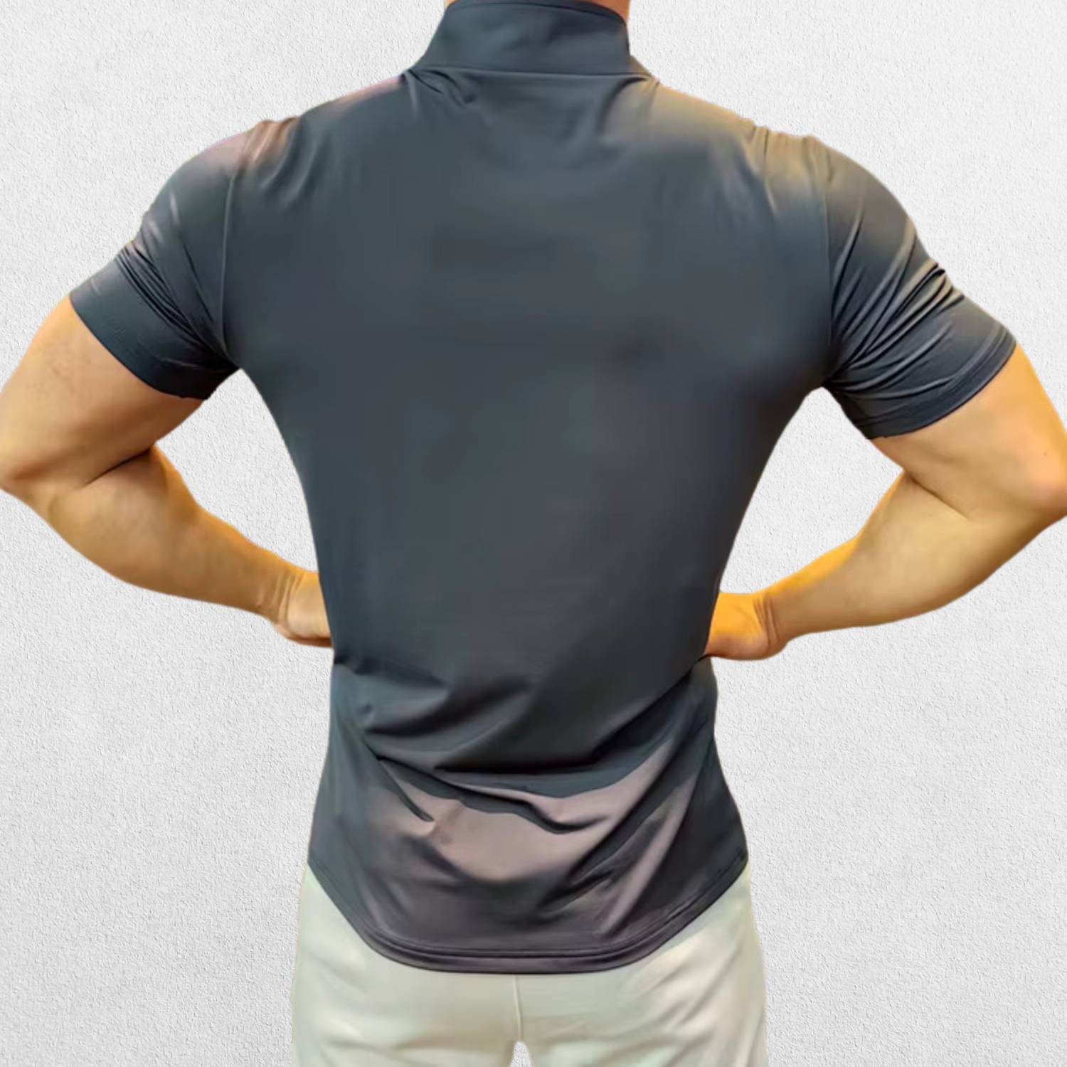 Back view of the GPW Men's High-Performance Short Sleeve Training Shirt in grey, showing the structured back panel and durable stitching against a professional studio setting.