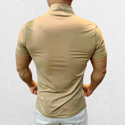 Back view of the GPW Men's High-Performance Short Sleeve Training Shirt in khaki, featuring a modern silhouette and reinforced seams against a plain studio setting.