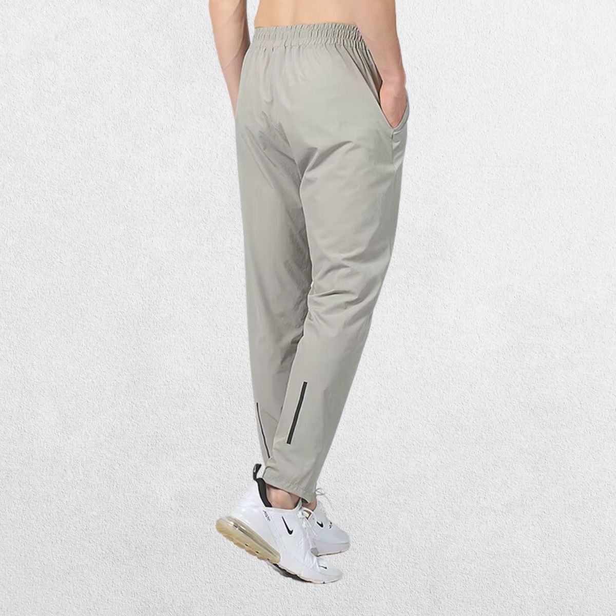 Back view of the GPW Men's Slim Fit Pencil Pants in grey, featuring the back pocket details and streamlined silhouette against a plain studio background.