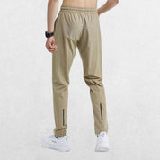 Back view of the GPW Men's Slim Fit Pencil Pants in khaki, showcasing the structured fit and stylish details against a minimal studio backdrop.