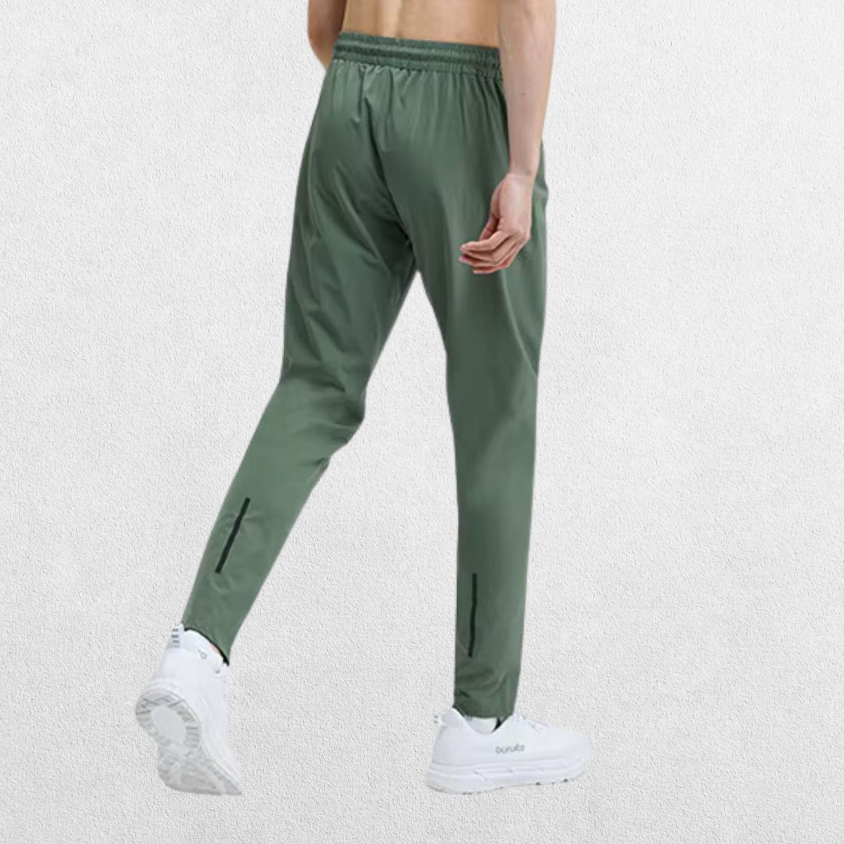 Back view of the GPW Men's Slim Fit Pencil Pants in light green, showcasing the practical back pocket and stylish tapered fit against a simple studio background.