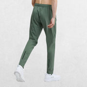 Back view of the GPW Men's Slim Fit Pencil Pants in light green, showcasing the practical back pocket and stylish tapered fit against a simple studio background.