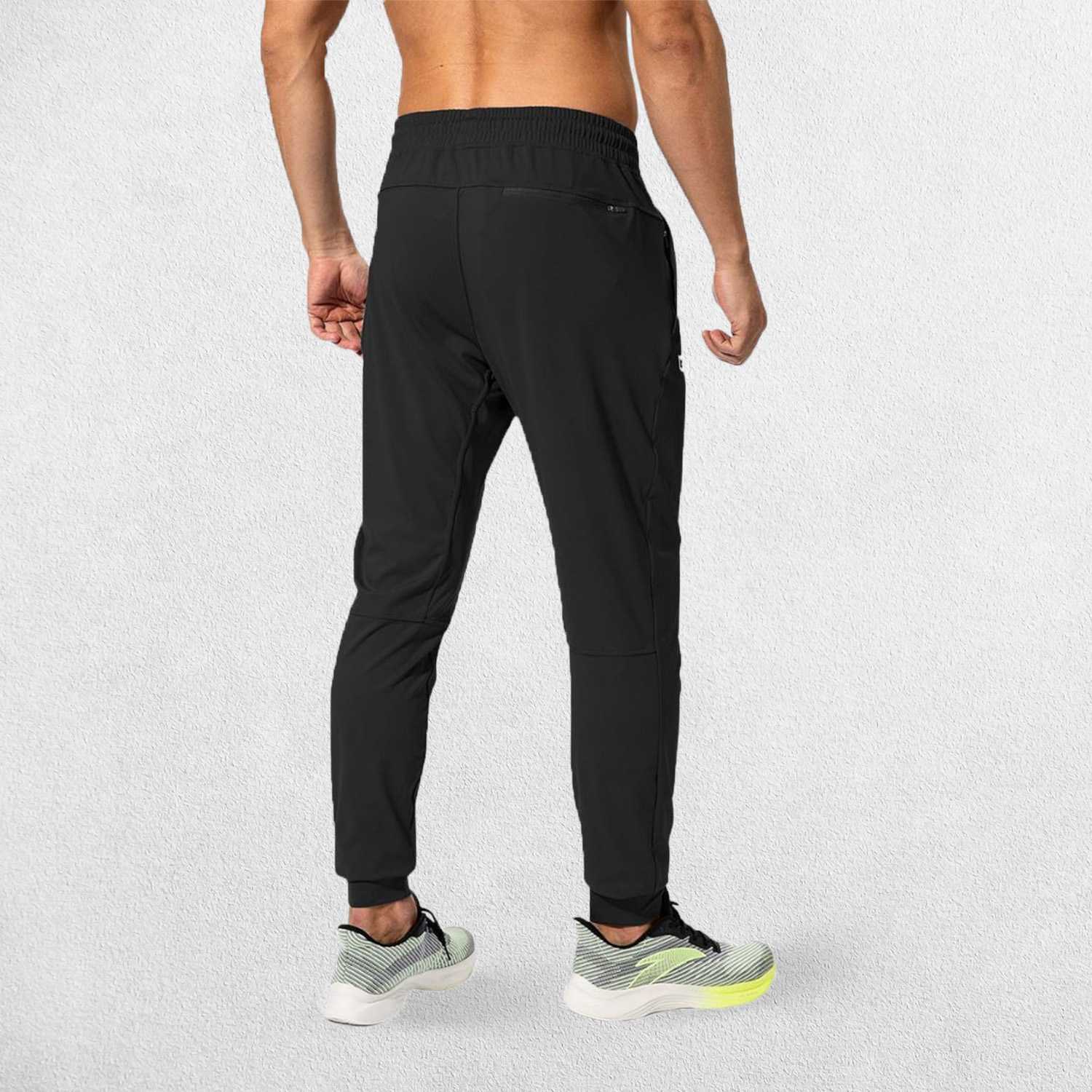 Rear view of Black GPW Men's Sweatpants showcasing their flexible and comfortable fit.