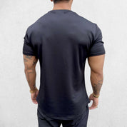 Close-up of Black GPW Men's Fit Summer Gym T-Shirt - Bodybuilding Streetwear Tee in a studio background