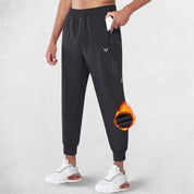 Side profile Of Black Men Fiece Trousers showcasing the deep pockets and athletic fit of the trousers.