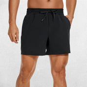 Front Close-up of Black GPW Men's Lightweight Quick-Dry Workout Shorts with Pockets in a studio background