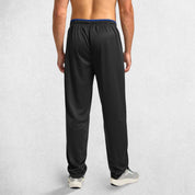 Back pose of Model Wearing Black GPW Men’s Open-Bottom Workout Trousers with Zip Pockets and Lightweight Mesh