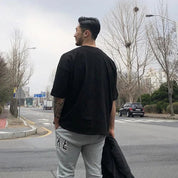 Model wearing Black GPW Men's Oversized T-Shirt - Casual Gym Bodybuilding Top