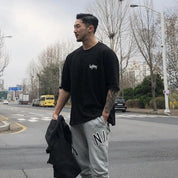 Model wearing Black GPW Men's Oversized T-Shirt - Casual Gym Bodybuilding Top