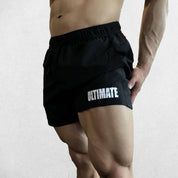 Model wearing Black GPW Men's Quick-Dry Fitness Shorts - Loose Beach Workout Bottoms