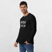 Model wearing the Black GPW Never Give Up Performance Long Sleeve Tee with jeans in a studio background.
