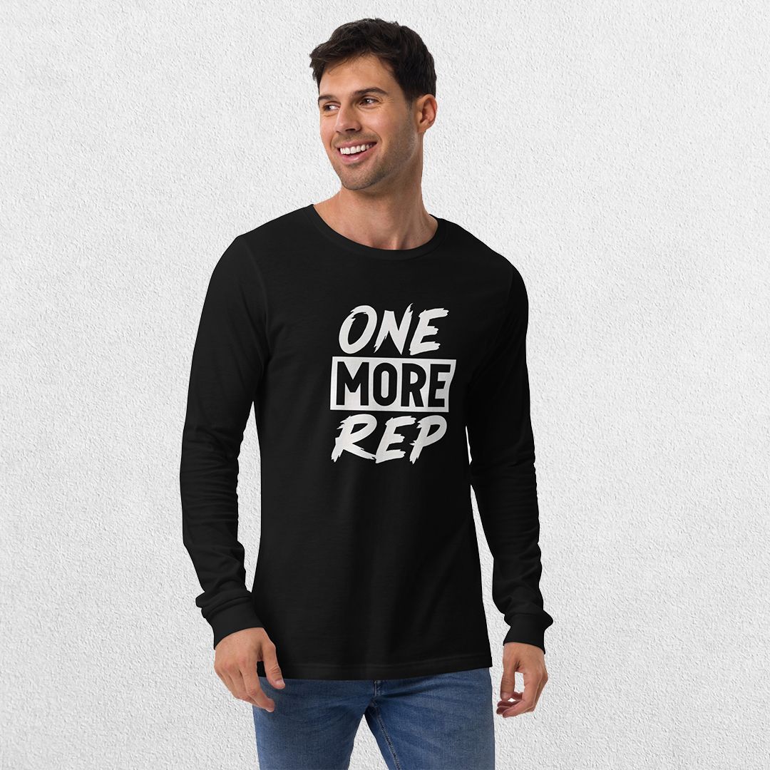 Model wearing the Black GPW One More Rep Unisex Motivational Long Sleeve Tee with jeans in studio background.