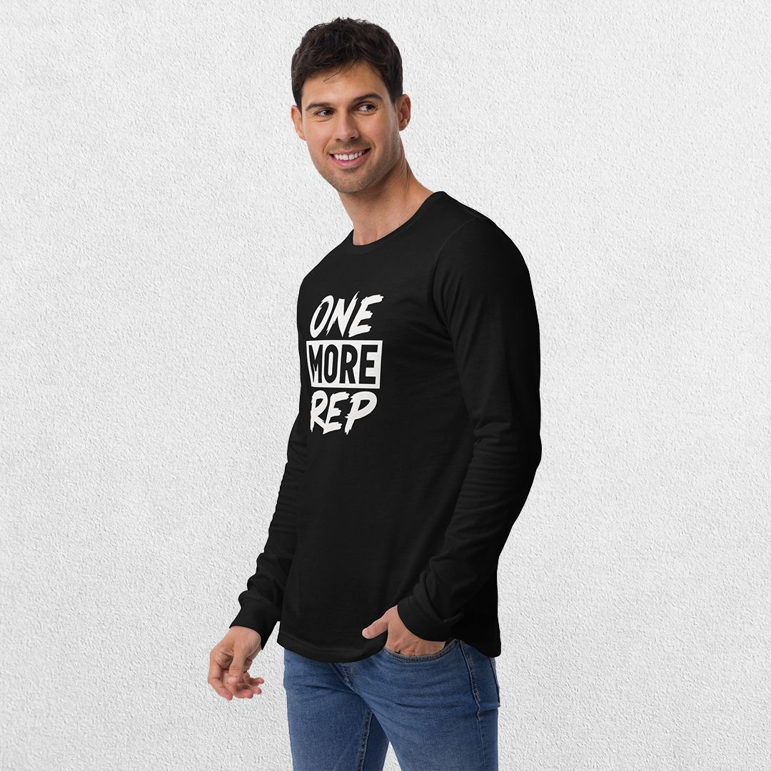Model wearing the Black GPW One More Rep Unisex Motivational Long Sleeve Tee with jeans in studio background.