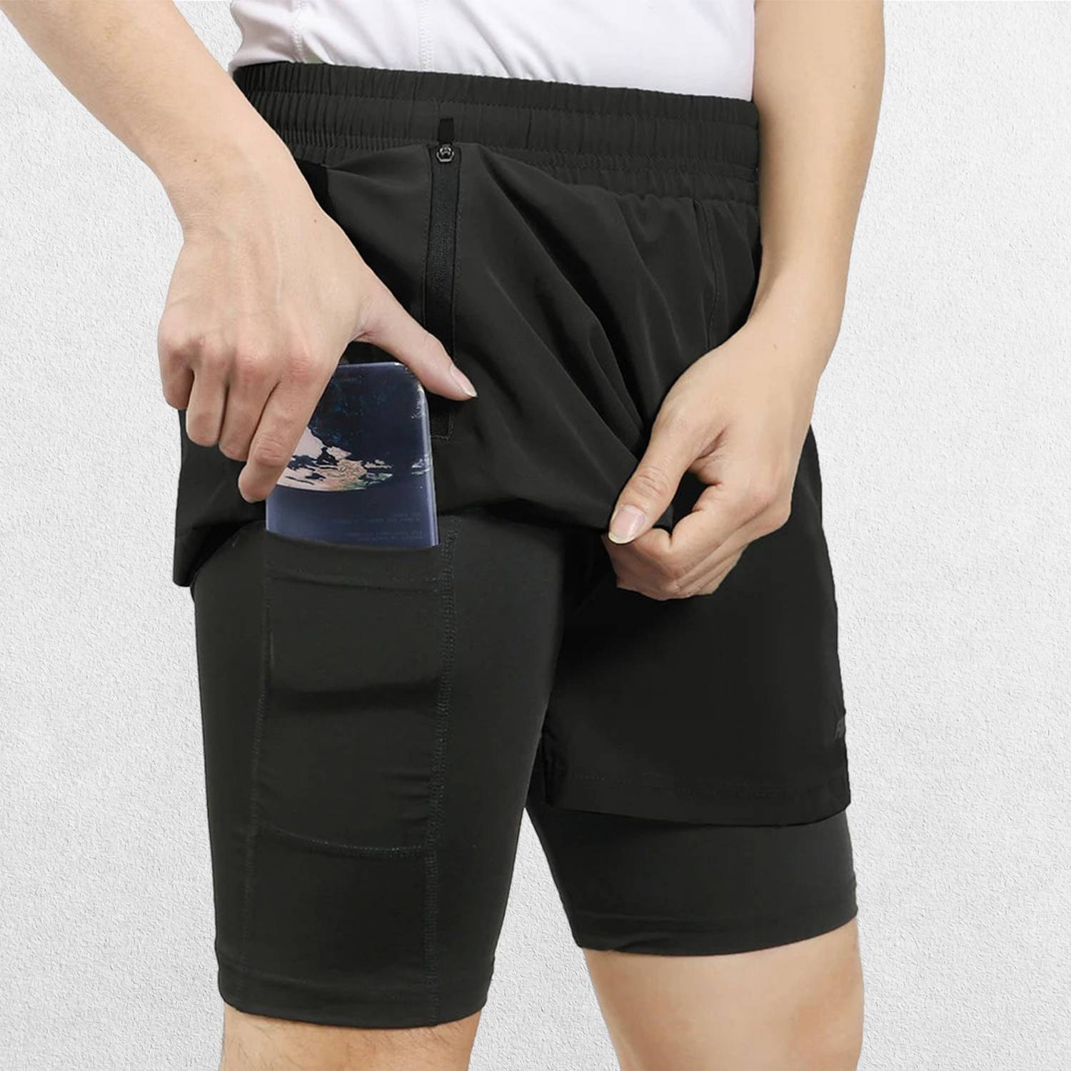 Close-up of Black Men’s Breathable 2-in-1 Gym Shorts with Zipper Pockets & Drawstring Fit in a studio background