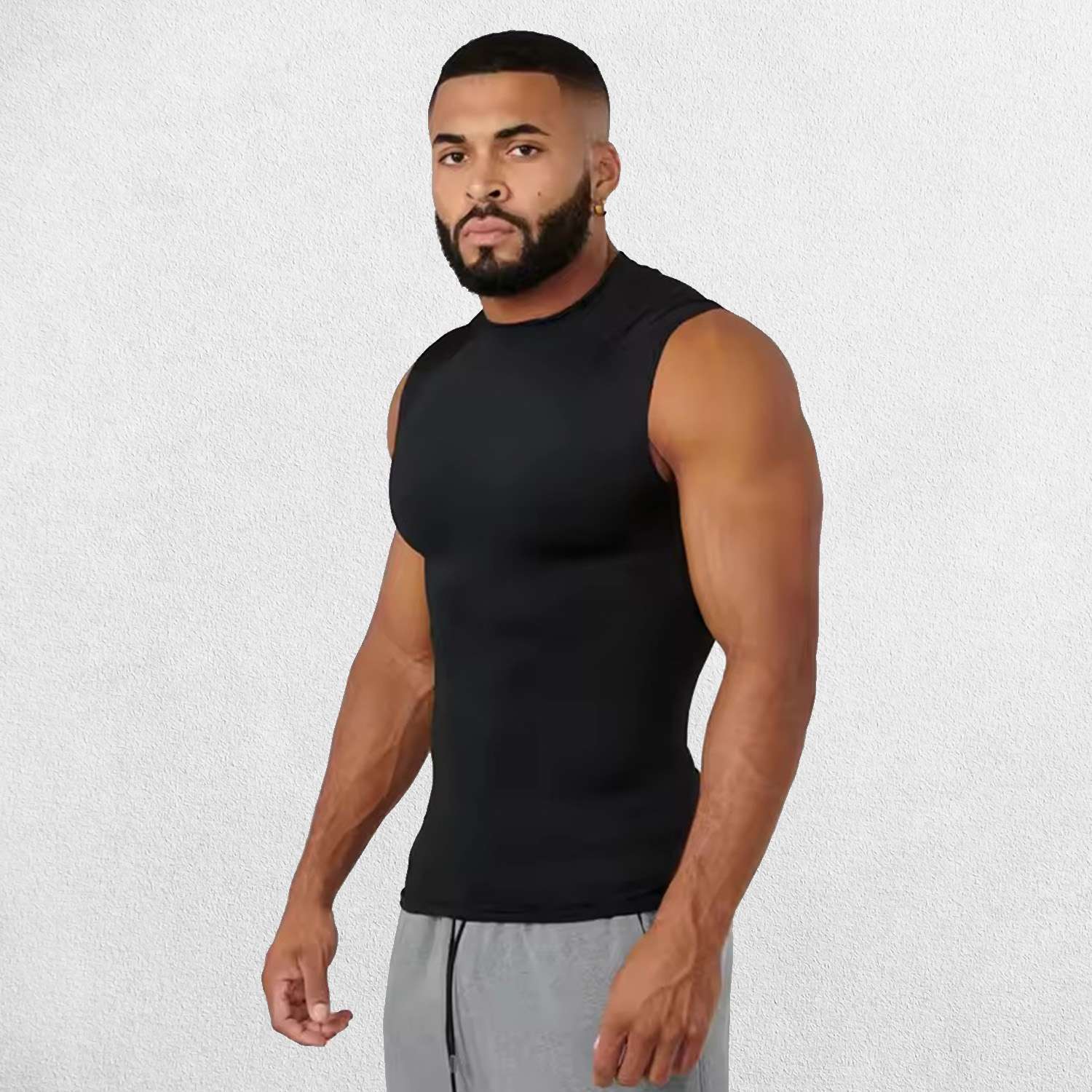 Model Wearing Black Men’s Compression Cut-Off Tank Top with breathable fabric, showcasing a sleek design and snug fit for optimal muscle support.