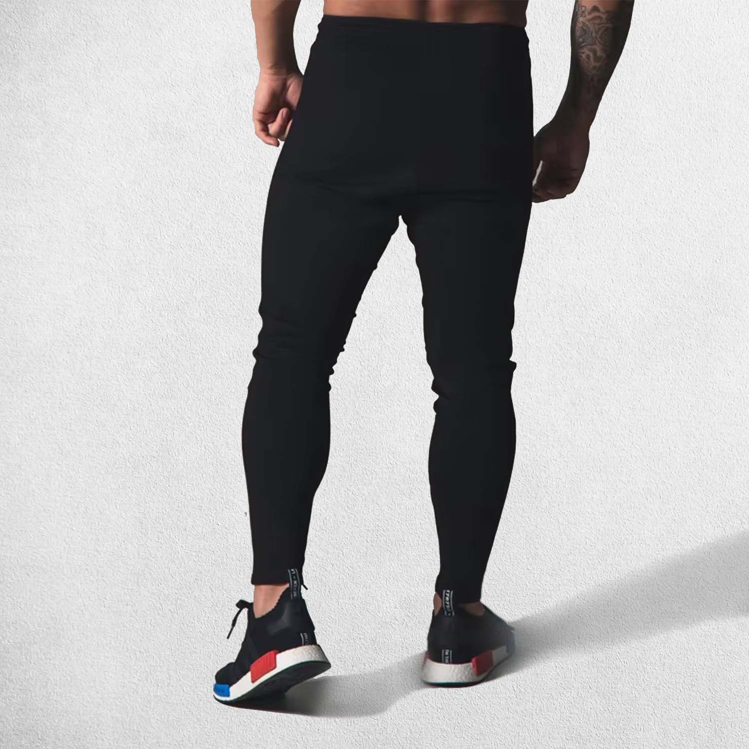 Back View of Model Wearing Black High-quality cotton joggers with durable stitching and elastic waist