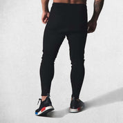 Back View of Model Wearing Black High-quality cotton joggers with durable stitching and elastic waist