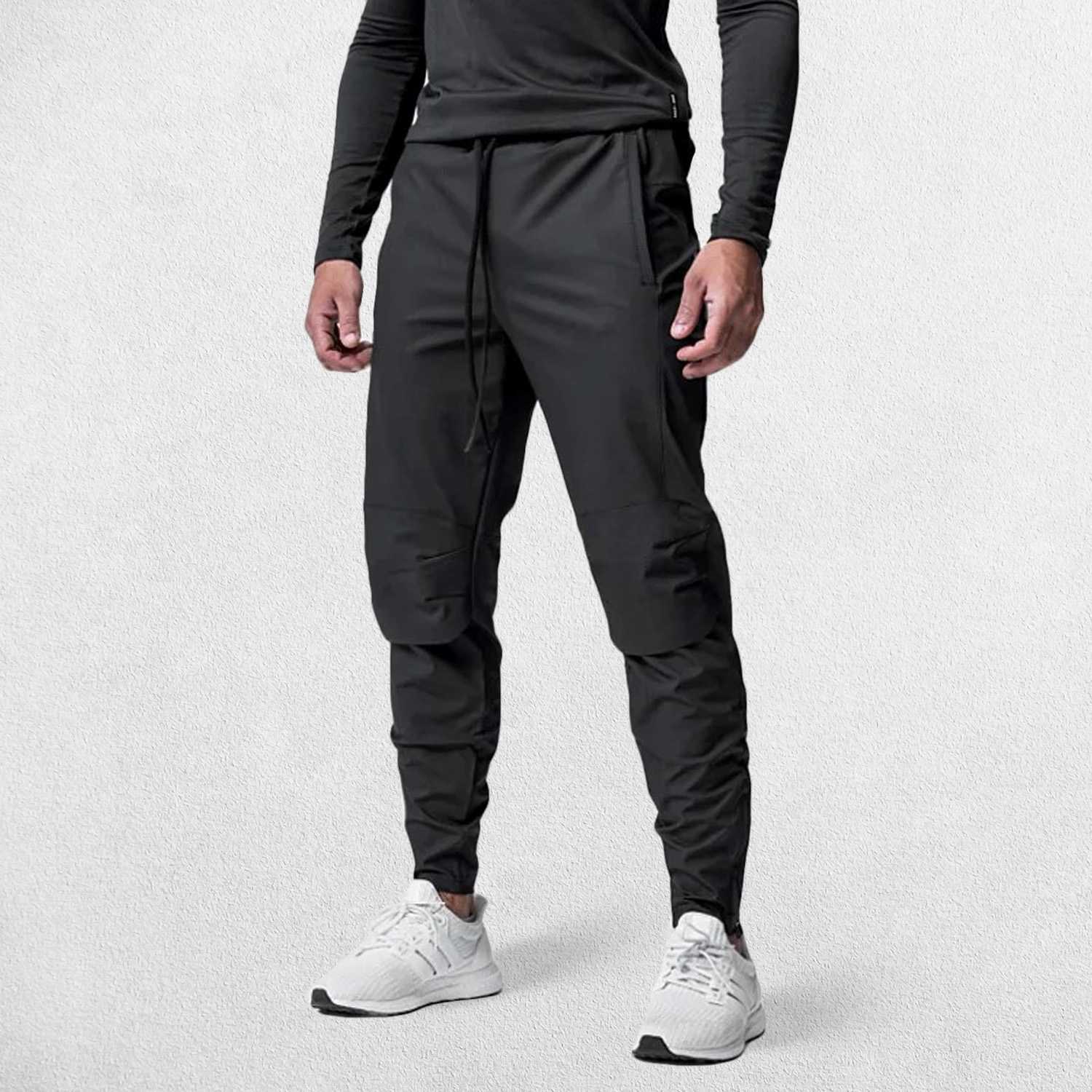 Fron tpose of Model Wearing Black Men's Quick-Dry Gym Track Pants highlighting breathable fabric.