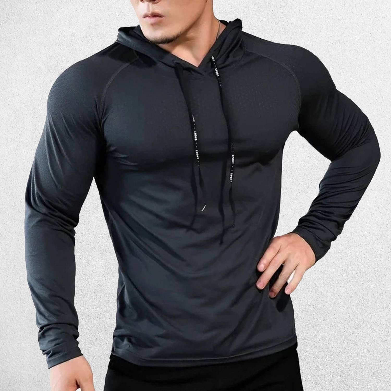 Model wearing Black men’s slim-fit hooded sports top in action during fitness training.