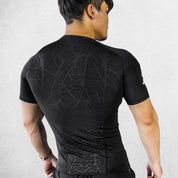 Back Pose Of Model Weaing Black Muscular Men’s Compression Sports T-Shirt – Quick-Dry, Slim-Fit Training & Fitness Tee for Gym, Running, and Workouts