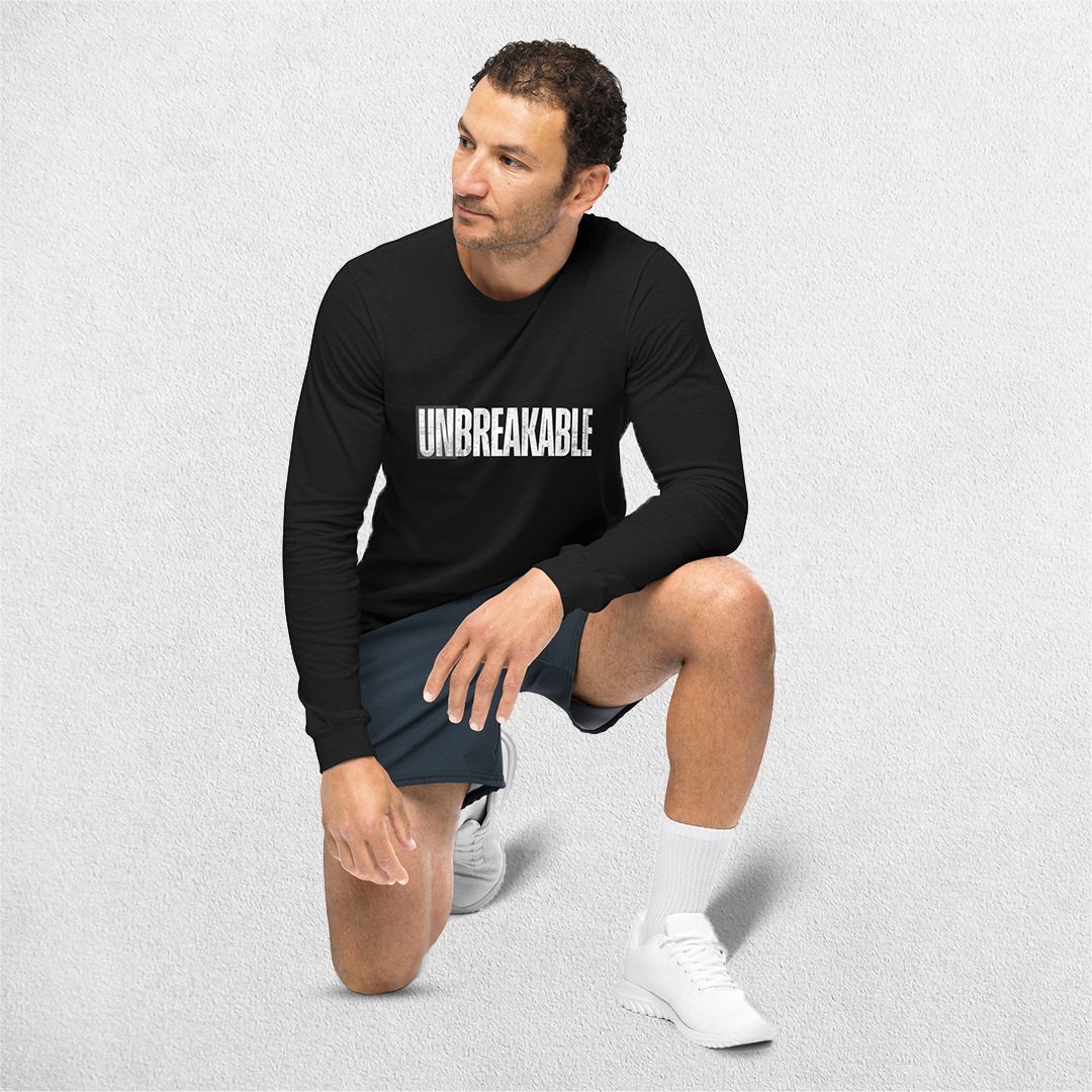 Sitting Model wearing the Athletic Heather Unbreakable Printed Unisex Long Sleeve Tee – Durable and Versatile Style