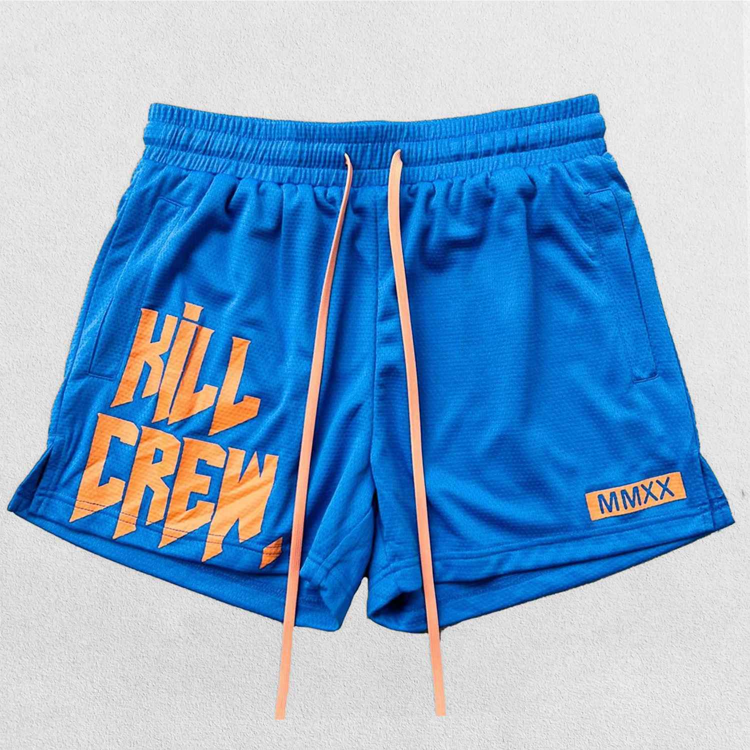 Close-up of Blue bold Kill Crew graphic print shwing its durability on GPW gym shorts.