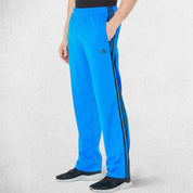 Side Pose of Model Wearing Blue Rush 3-Stripes Tracksuit Pants made with Primegreen fabric