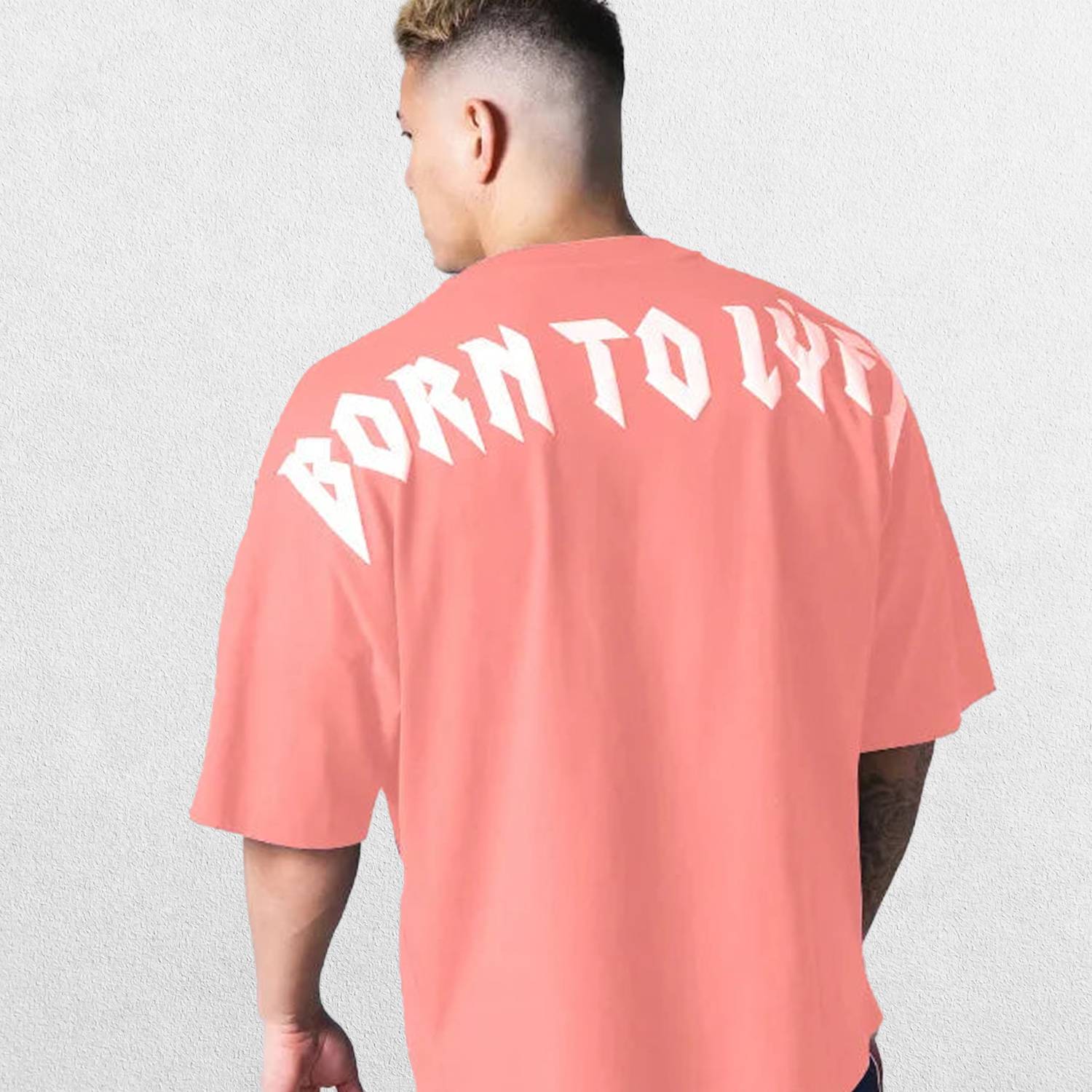 Model wearing Coral Pink GPW Oversized T-Shirt, styled for streetwear and gym.