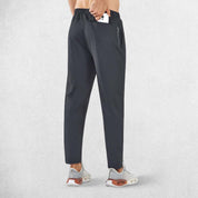 Back Pose of model wearing Dark Grey  GPW Men’s Joggers with zipper pockets storing essentials.