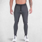 Front view of model wearing DArk Grey GPW Men's Slim Fit Trousers with Zipper Pockets for Training