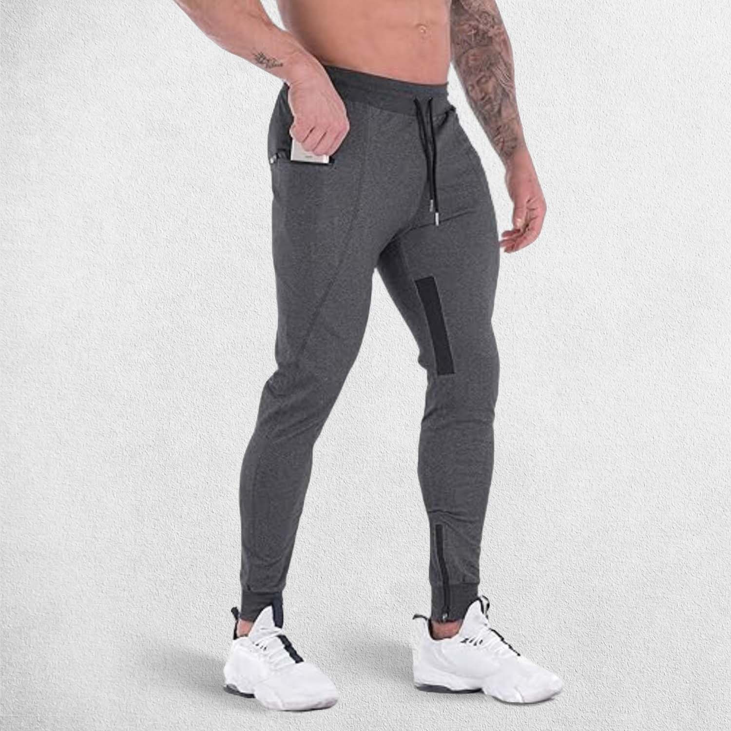 Side pose of model wearing Practical zipper pocket securely holding a phone in GPW athletic trousers.