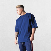 Model wearing Dark Blue GPW Oversized T-Shirt, styled for streetwear and gym.