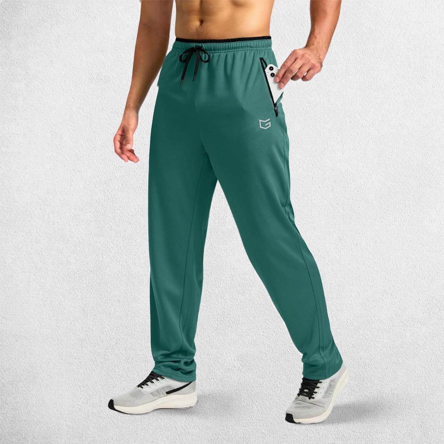 Model Showcasing Secure zippered pocket holding a smartphone on GPW Men’s athletic trousers.