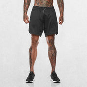Model Wearing Dark Grey GPW Men's 2-in-1 Running Shorts for Gym & Fitness Workouts