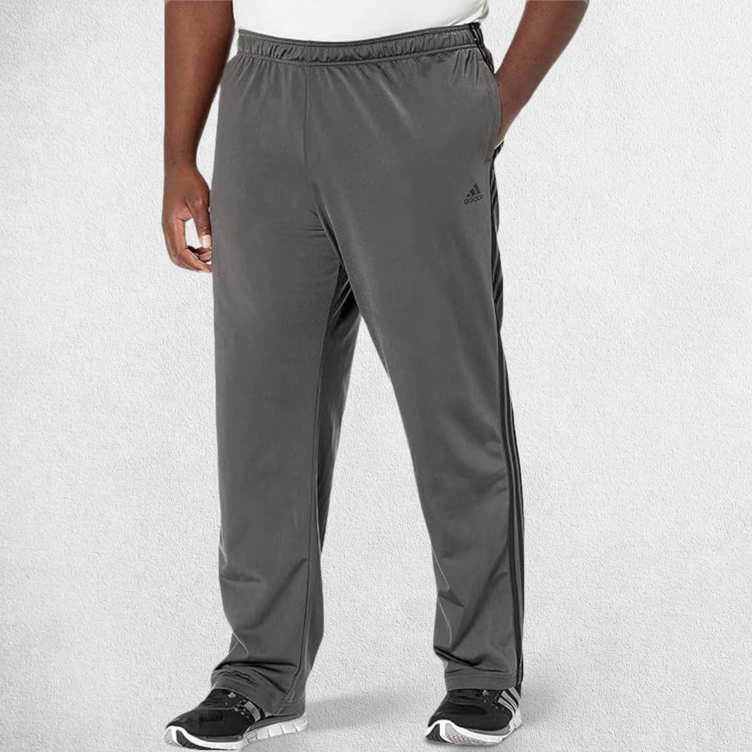 Front Pose Of Model Wearing Dark Grey Heather 3-Stripes Tracksuit Pants made with Primegreen fabric