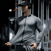 Model In a gym wearing slim-fit compression shirt with zipper and stretch fabric