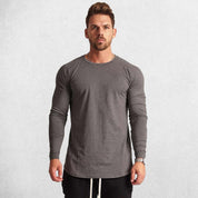 Model Wearing Dark Grey Men’s Slim Fit Cotton Fitness Long Sleeve T-Shirt – Front view showcasing O-neck design and letter pattern for casual and gym wear.