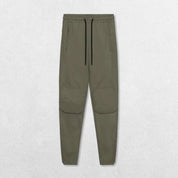 Full-length shot of Dark Olive Green pants styled for both gym and casual wear.