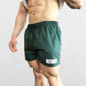 Model wearing Dark State Green Blue GPW Men's Quick-Dry Fitness Shorts - Loose Beach Workout Bottoms