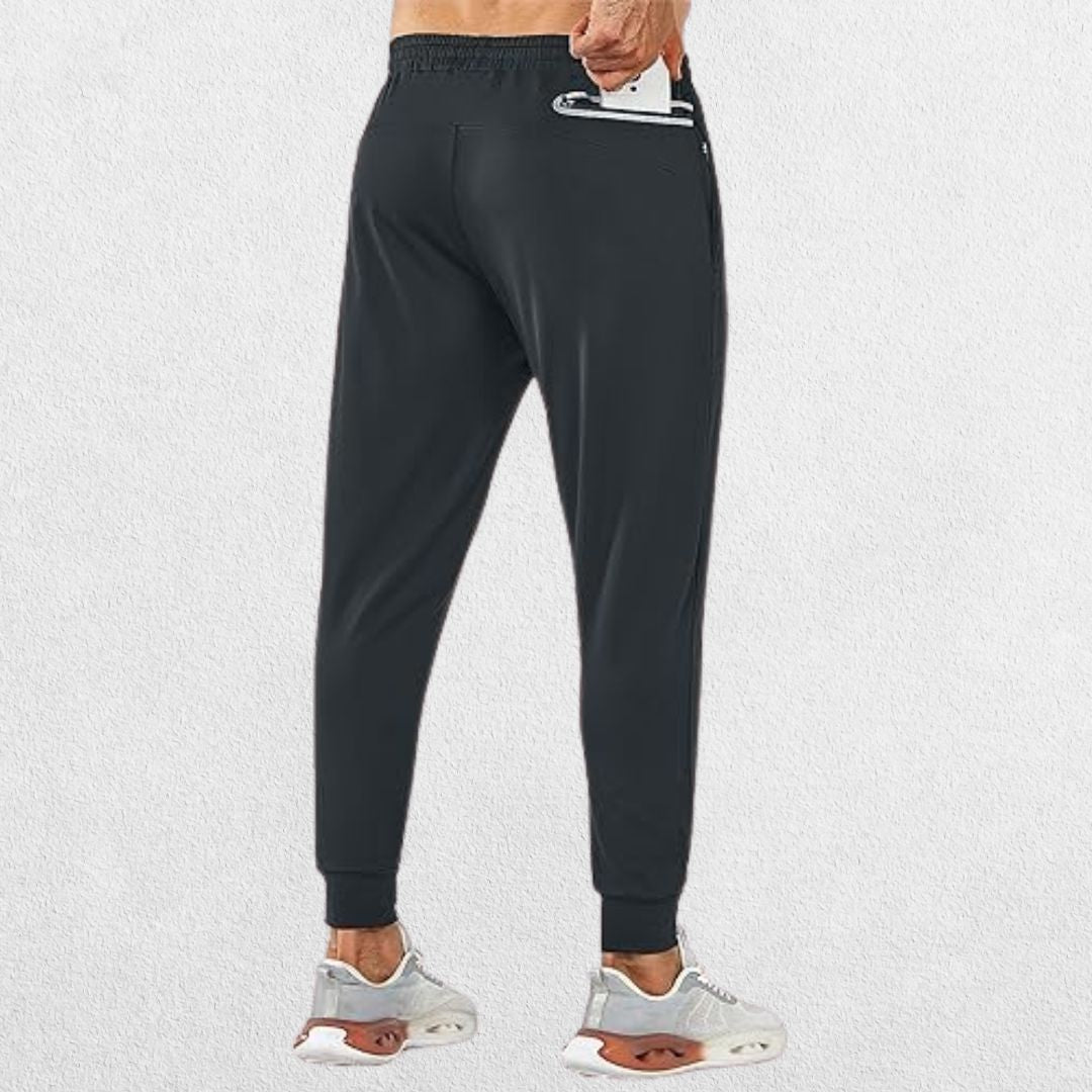 Model demonstrating secure zipper pocket on GPW Men's Lightweight Trousers, perfect for storing essentials during workouts or casual wear.