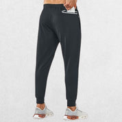 Model demonstrating secure zipper pocket on GPW Men's Lightweight Trousers, perfect for storing essentials during workouts or casual wear.