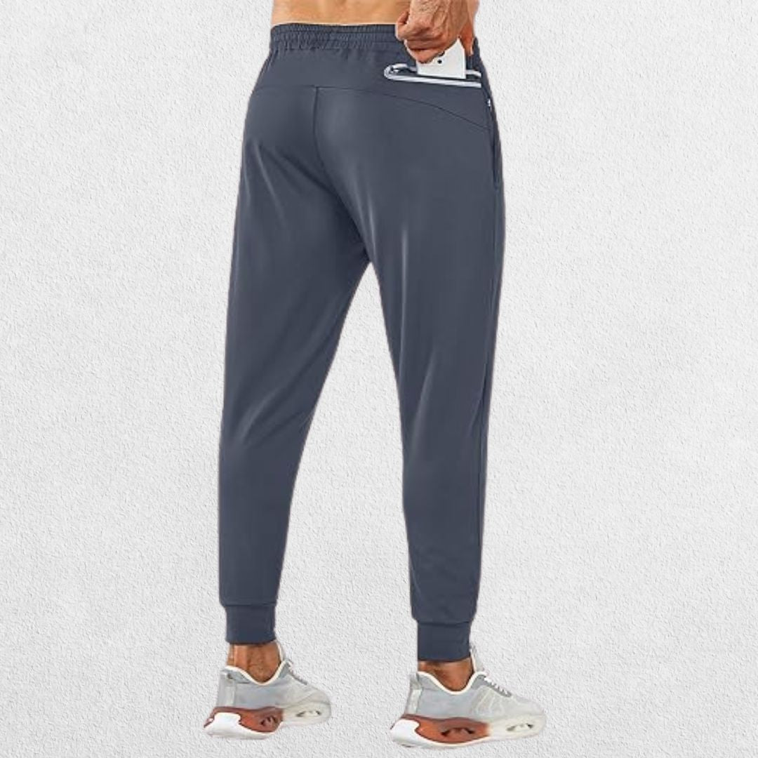 Men's dark grey lightweight trousers with zipper pocket, model demonstrating