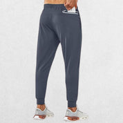 Men's dark grey lightweight trousers with zipper pocket, model demonstrating